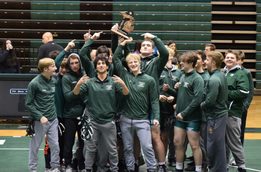 The boys varsity wrestling team clinches a district title and sends two wrestlers to regionals