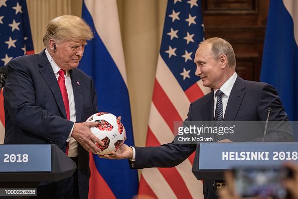 HELSINKI, FINLAND - JULY 16:  Russian President Vladimir Putin hands U.S. President Donald Trump (L) a World Cup football during a joint press conference after their summit on July 16, 2018 in Helsinki, Finland. The two leaders met one-on-one and discussed a range of issues including the 2016 U.S Election collusion.  (Photo by Chris McGrath/Getty Images)