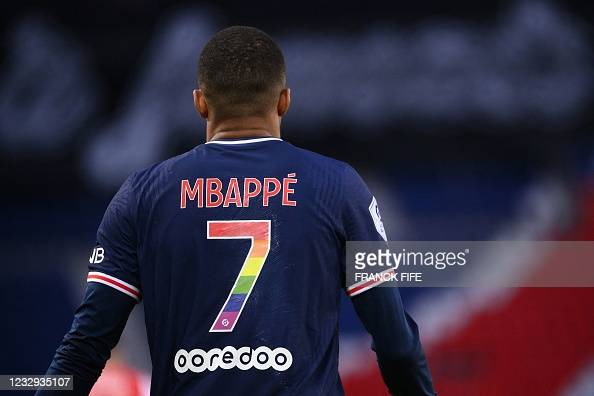 Paris Saint-Germains French forward Kylian Mbappe, wearing a jersey in the colour of the Rainbow flag marking the fight against homophobia, walks on the pitch during the French L1 football match between Paris Saint-Germain and Stade de Reims at the Parc des Princes stadium in Paris on May 16, 2021. - The 37th day of Ligue 1 on May 16 was an opportunity for French football to raise public awareness about the fight against homophobia, through various operations in the stadiums. (Photo by FRANCK FIFE / AFP) (Photo by FRANCK FIFE/AFP via Getty Images)