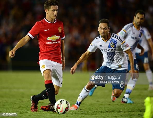 Manchester Uniteds Ander Herrera passes under pressure fromMarcelo Sarvas of the LA Galaxy during their Chevrolet Cup match at the Rose Bowl in Pasadena, California on July 23, 2014.  AFP PHOTO/Frederic J. Brown (Photo by Frederic J. BROWN / AFP)        (Photo credit should read FREDERIC J. BROWN/AFP via Getty Images)