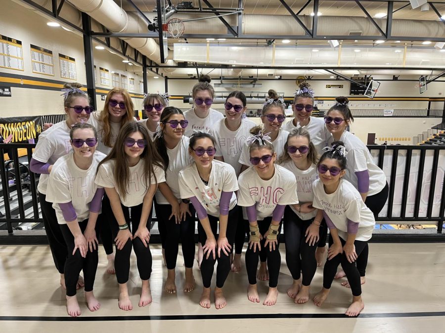 The Forest Hills gymnastics team poses in their stylish sunglasses. 