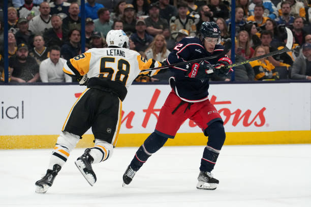COLUMBUS, OHIO - APRIL 13: Mikael Pyyhtia #82 of the Columbus Blue Jackets battles Kris Letang #58 of the Pittsburgh Penguins for position during the second period Nationwide Arena on April 13, 2023 in Columbus, Ohio. (Photo by Jason Mowry/Getty Images)