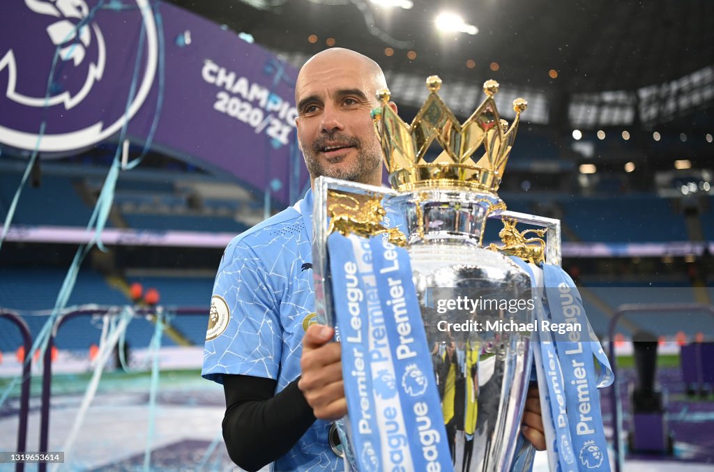 MANCHESTER%2C+ENGLAND+-+MAY+23%3A+Pep+Guardiola%2C+Manager+of+Manchester+City+celebrates+with+the+Premier+League+Trophy+as+Manchester+City+are+presented+with+the+Trophy+as+they+win+the+league+following+the+Premier+League+match+between+Manchester+City+and+Everton+at+Etihad+Stadium+on+May+23%2C+2021+in+Manchester%2C+England.+A+limited+number+of+fans+will+be+allowed+into+Premier+League+stadiums+as+Coronavirus+restrictions+begin+to+ease+in+the+UK.+%28Photo+by+Michael+Regan%2FGetty+Images%29